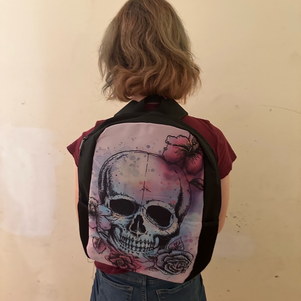 Never been used fun skull backpack. It’s pretty big and can hold a laptop.